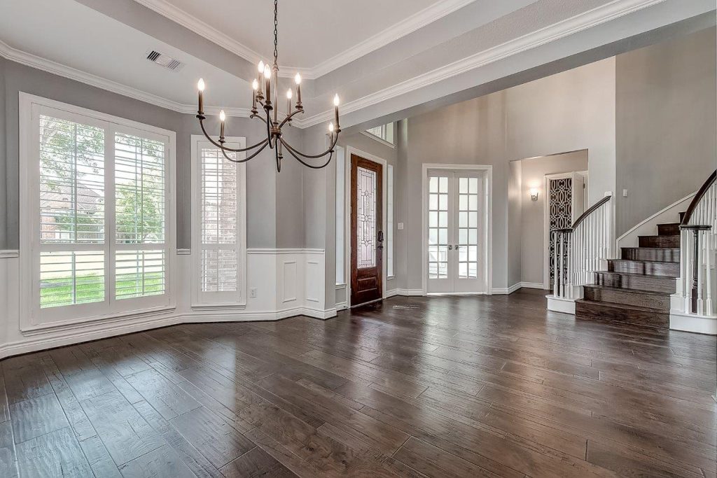 interior view of modern home foyer with chandelier and curved staircase