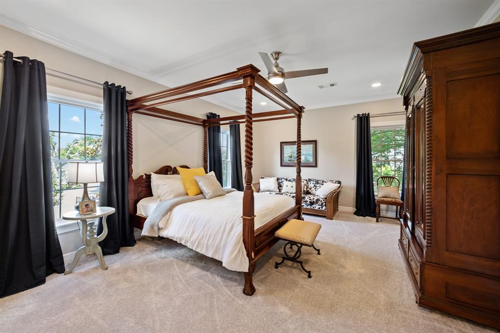 a clean and nicely furnished bedroom with large vinyl windows installed