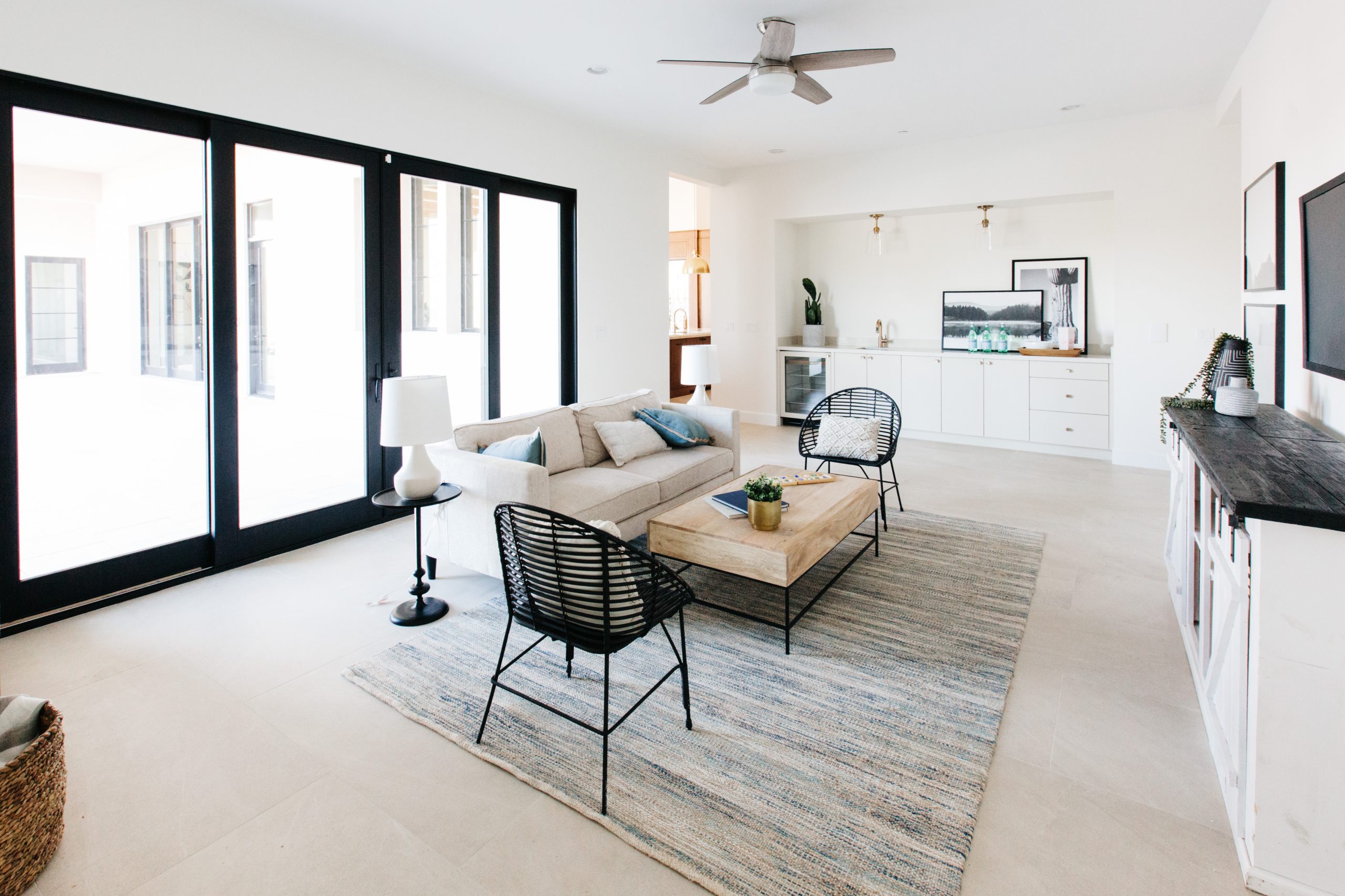 New Website Launch for Milestone Windows! Rosenberg, TX luxury modern living room with sliding doors leading to patio