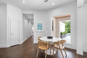 modern dining area with large picture window behind