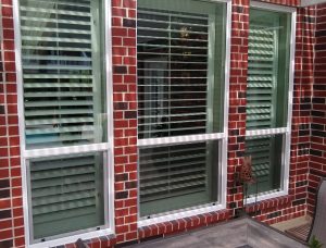 Exterior view of red brick home with single hung windows