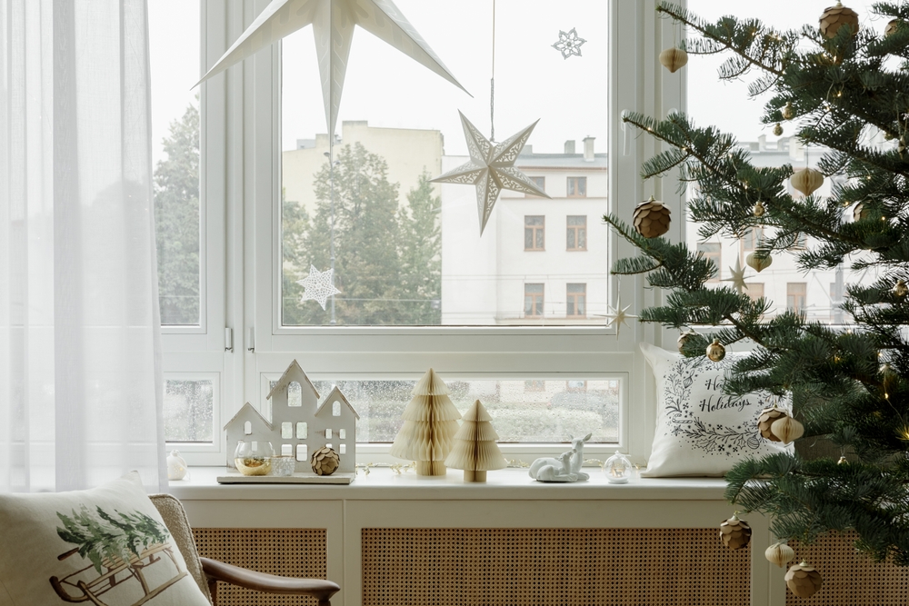 Holiday Cheer & Cozy Homes with Milestone Windows Holiday window view. Simple and elegant Christmas window decor with star ornaments and a beautifully decorated tree. Cozy and festive.