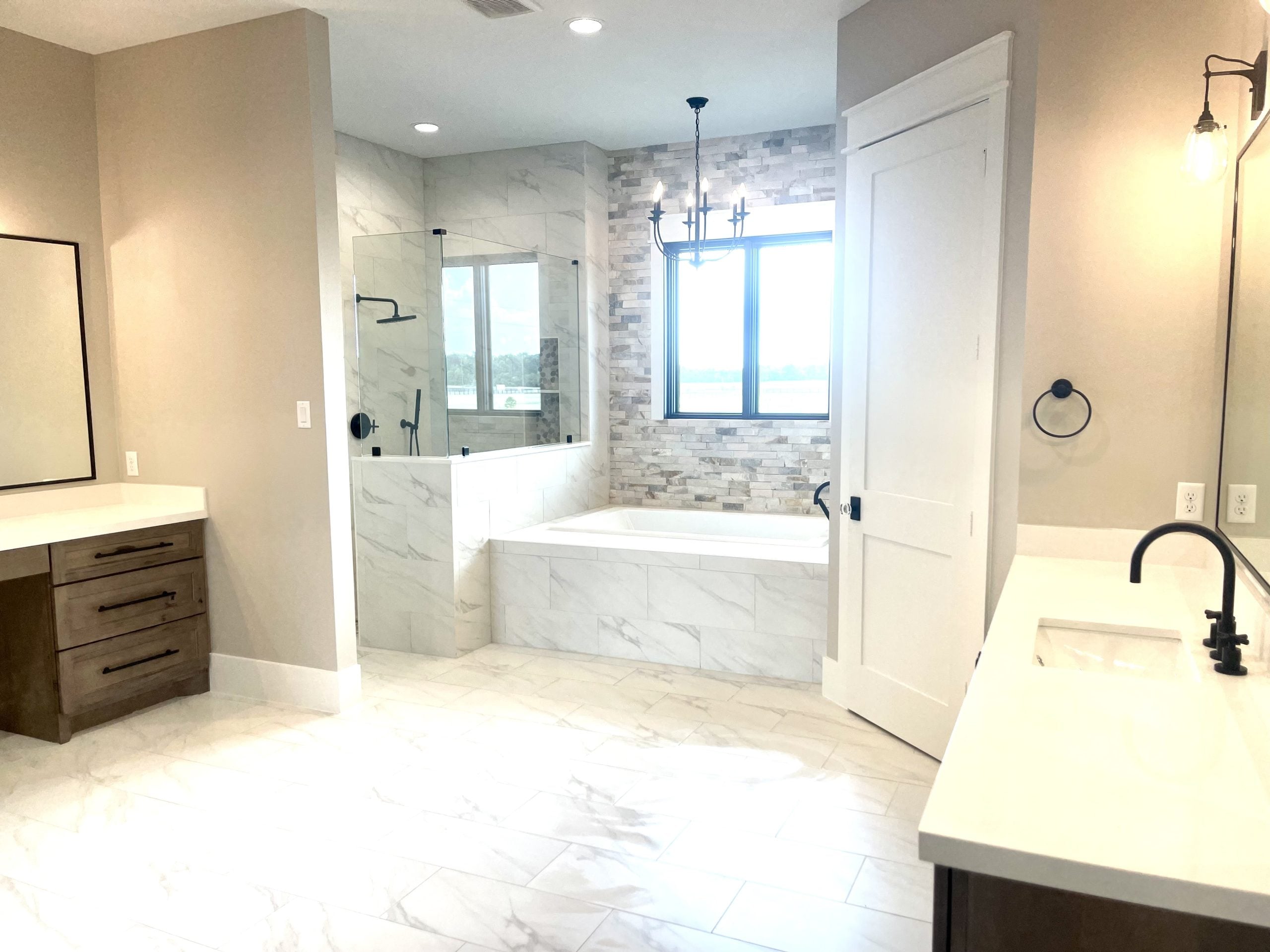 What Is a Good U-Factor for Windows? Ratings Explained Interior view of a bright modern bathroom with light shining through single hung windows.