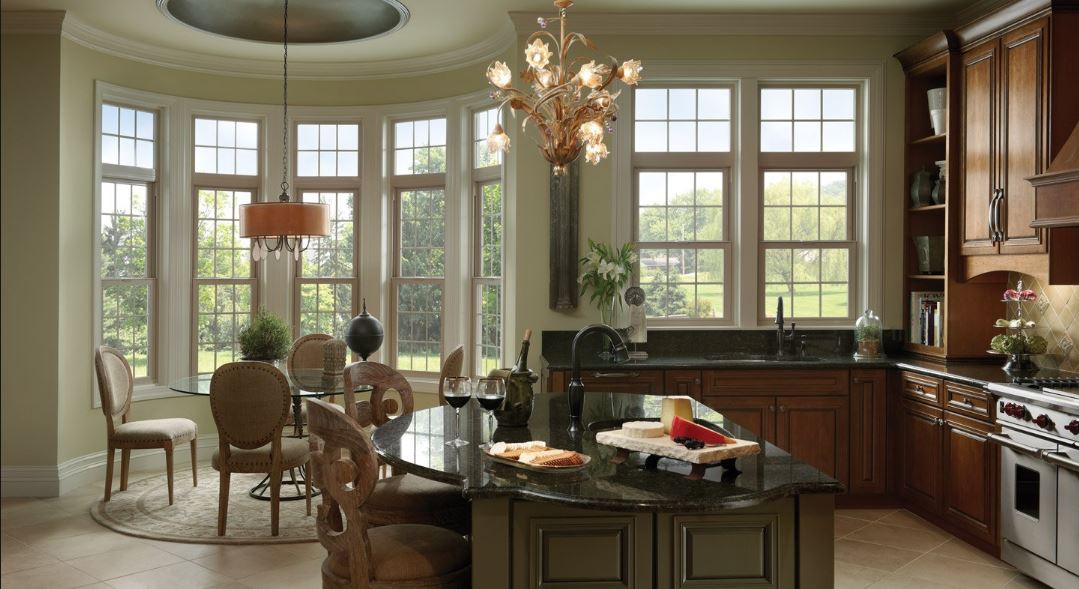 7 tips for choosing wood clad windows for your replacement 7 tips for choosing wood clad windows for your replacement's kitchen and dining area with wood clad windows letting light in.