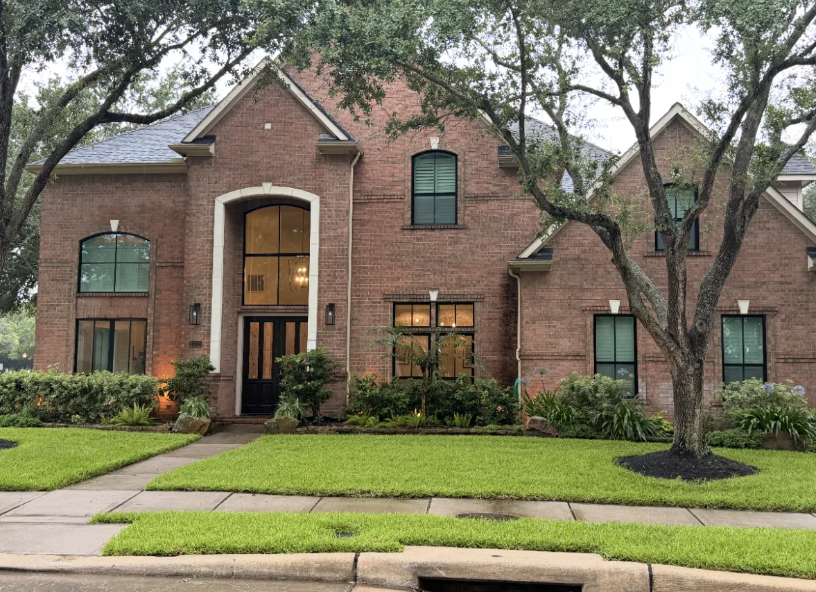 Professional Installing Replacement Windows in a Brick House NT Windows Black Thermal Aluminum Low-E Glass on a brick house.
